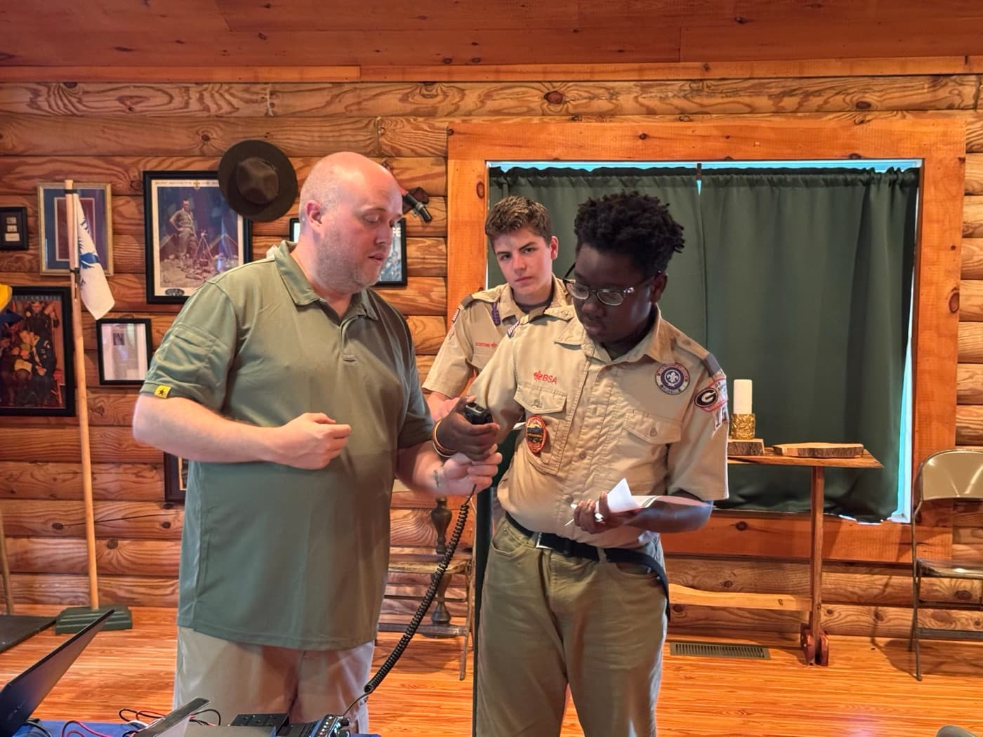 Chris coaching two Scouts through their first contacts on a handheld radio